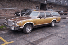 a brown and white station wagon with a license plate that says ' nc ' is parked in a parking lot