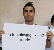 a man holds up a sign that says i 'm too playing like 47 mode