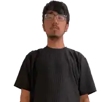 a man wearing glasses and a black shirt is using sign language