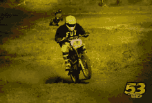 a person riding a dirt bike with the number 53