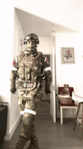 a man in a military uniform stands in a hallway