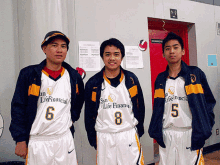 three basketball players are posing for a picture and one has the number 6 on his jersey