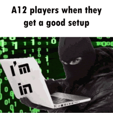 a man in a ski mask is using a laptop with the words " i 'm in " on the screen