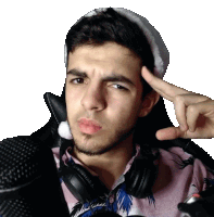 a man wearing headphones and a hat is giving the peace sign