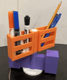 a 3d printed pencil holder with markers and pens