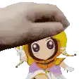 a hand is putting a hat on a little girl .