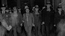 a black and white photo of a group of men with one man wearing a badge that says ' george ' on it