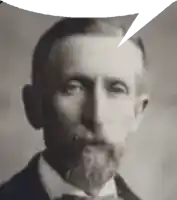 a man with a beard is wearing a suit and bow tie and has a speech bubble above his head