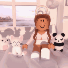 a girl sitting on a bed with stuffed animals including a panda bear and a cat