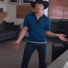 a man wearing a cowboy hat is standing in a living room
