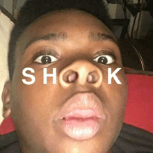 a close up of a man 's face with the word shook written on his face