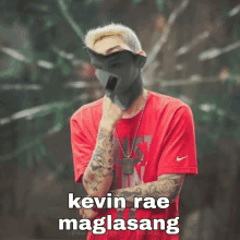 a man wearing a red shirt with the words kevin rae maglasang