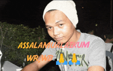 a man wearing a beanie and a t-shirt that says ' assalamualaikum ' on it