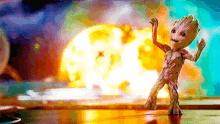 groot from guardians of the galaxy 2 is dancing in front of a giant explosion .