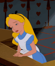 a cartoon of alice from alice in wonderland sitting at a table