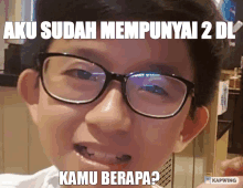 a young boy wearing glasses has a caption that says aku sudah mempunyai 2 di kamu berapa