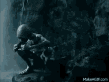 a gollum from the lord of the rings is squatting down