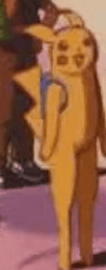 a close up of a yellow cartoon character standing on a table .