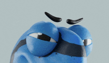 a close up of a blue cartoon character 's face with a black eyebrow