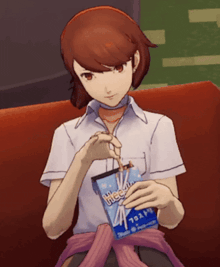a girl is sitting on a couch holding a bag that says " free " on it