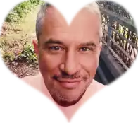 a man 's face is surrounded by a heart shaped frame