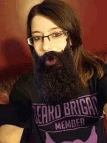 a woman wearing glasses and a beard is wearing a beard brigg member shirt .