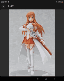 a figurine of a girl with a sword is displayed on a cell phone screen