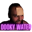 a man with a piece of paper on his forehead and the words dooky water behind him .