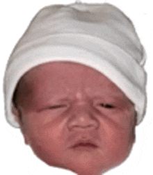 a baby wearing a white hat is crying .