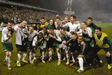 a group of soccer players are posing for a picture with one wearing a jersey that says ' allianz ' on it