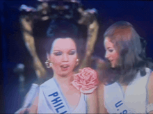 a woman is wearing a sash that says philip on it