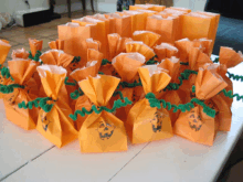 a bunch of orange bags with pumpkin faces on them