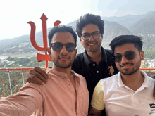 three men are posing for a picture with one wearing a levi 's shirt