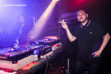 a man smoking a cigarette in front of a pioneer dj turntable