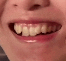 a close up of a person 's mouth with teeth and red lips .