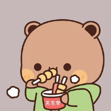 a cartoon teddy bear is eating noodles with a straw from a cup .