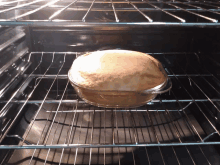 a pie in a glass dish in an oven with the door open