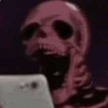 a skeleton is holding a cell phone in his hand .