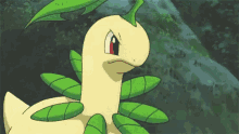 a close up of a pokemon with green leaves on its body