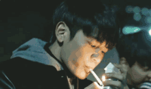 a man lighting a cigarette with a lighter