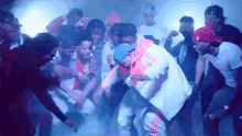 a group of young men are dancing in a dark room with smoke coming out of it