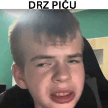 a young boy is making a funny face with the words drz picu above him