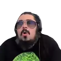a man with a beard and sunglasses is wearing headphones and a black shirt .