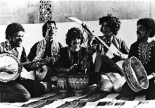 a black and white photo of a group of men playing instruments .