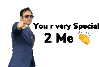 a man in a suit is pointing at a sign that says you 're very special 2 me