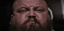 a close up of a man with a bloody nose and beard .