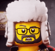 a lego man with a beard and glasses is wearing a white wig