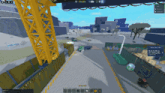 a screenshot of a video game with a yellow crane and a green truck