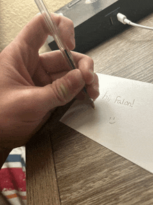 a person is writing a note to hi falon