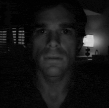 a black and white photo of a man 's face